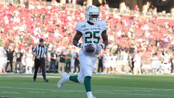 Sep 16, 2023; Stanford, California, USA; Sacramento State Hornets running back Elijah Tau-Tolliver (25) scores a touchdown during the second quarter against the Stanford Cardinal at Stanford Stadium. Mandatory Credit: Sergio Estrada-Imagn Images Sep 16, 2023; Stanford, California, USA; Sacramento State Hornets running back Elijah Tau-Tolliver (25) scores a touchdown during the second quarter against the Stanford Cardinal at Stanford Stadium. Mandatory Credit: Sergio Estrada-Imagn Images