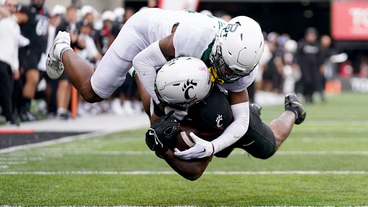 Cincinnati Bearcats wide receiver Xzavier Henderson (8) dives in the end zone after catching a touchdown pass in the fourth quarter during a college football game between the Baylor Bears and the Cincinnati Bearcats, Saturday, Oct. 21, 2023, at Nippert Stadium in Cincinnati. Cincinnati Bearcats wide receiver Xzavier Henderson (8) dives in the end zone after catching a touchdown pass in the fourth quarter during a college football game between the Baylor Bears and the Cincinnati Bearcats, Saturday, Oct. 21, 2023, at Nippert Stadium in Cincinnati.
