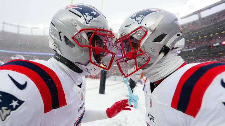 Jan 25, 2026; Denver, CO, USA;  New England Patriots cornerback Christian Gonzalez (0) and cornerback Carlton Davis III (7)  react after an interception during the 2026 AFC Championship Game at Empower Field at Mile High. Mandatory Credit: Ron Chenoy-Imagn Images