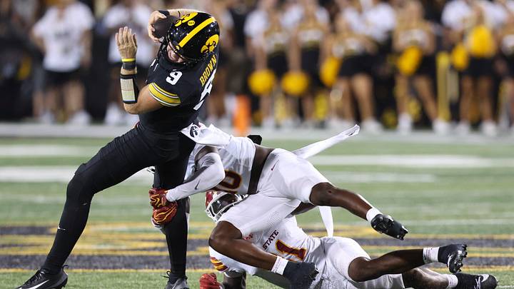 Sep 12, 2026; Iowa City, Iowa, USA;  dIowa Hawkeyes quarterback Hank Brown (9) is tackled by Iowa State Cyclones safety Eddie Lemos (19) during the fourth quarter at Kinnick Stadium.  Mandatory Credit: Reese Strickland-Imagn Images