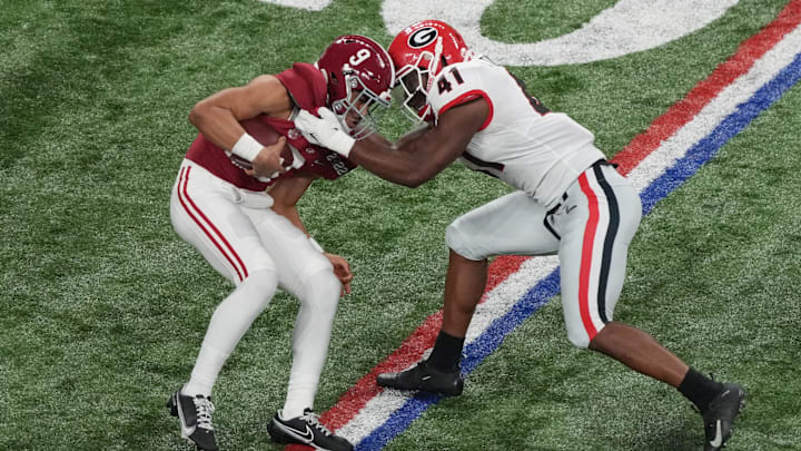 Jan 10, 2022; Indianapolis, IN, USA; Alabama Crimson Tide quarterback Bryce Young (9) is sacked by Georgia Bulldogs linebacker Channing Tindall (41) in the second quarter during the 2022 CFP college football national championship game at Lucas Oil Stadium. Mandatory Credit: Joshua Bickel-Imagn Images Jan 10, 2022; Indianapolis, IN, USA; Alabama Crimson Tide quarterback Bryce Young (9) is sacked by Georgia Bulldogs linebacker Channing Tindall (41) in the second quarter during the 2022 CFP college football national championship game at Lucas Oil Stadium. Mandatory Credit: Joshua Bickel-Imagn Images