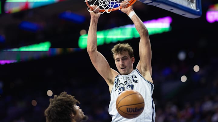 Orlando Magic forward Franz Wagner (22) dunks the ball in front of Philadelphia 76ers guard Kelly Oubre Jr. (9) during the first quarter at Wells Fargo Center.