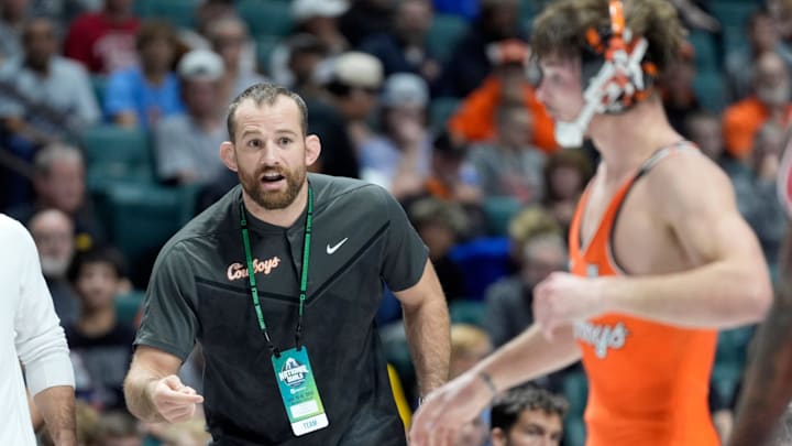 Oklahoma State wrestling coach David Taylor talks with Troy Spratley as he wrestles NC State's Vincent Robinson at 125 pounds during the National Duals Invitational at the BOK Center in Tulsa, Okla, Saturday, Nov. 15, 2025. Oklahoma State wrestling coach David Taylor talks with Troy Spratley as he wrestles NC State's Vincent Robinson at 125 pounds during the National Duals Invitational at the BOK Center in Tulsa, Okla, Saturday, Nov. 15, 2025.