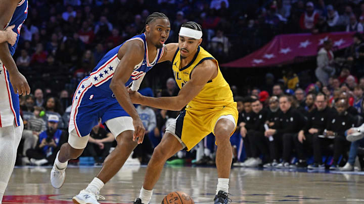 Jan 19, 2026; Philadelphia, Pennsylvania, USA; Philadelphia 76ers guard Tyrese Maxey (0) drivers past Indiana Pacers guard Andrew Nembhard (2) during the first quarter at Xfinity Mobile Arena. Mandatory Credit: Eric Hartline-Imagn Images
