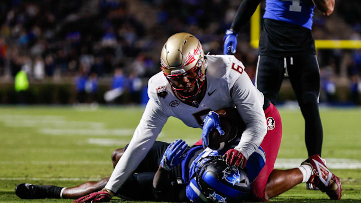 Oct 18, 2024; Durham, North Carolina, USA; Duke Blue Devils quarterback Maalik Murphy (6) attempts to run the ball to the end zone but is tacked by Florida State Seminoles defensive lineman Darrell Jackson Jr. (6) during the first half of the game at Wallace Wade Stadium. Mandatory Credit: Jaylynn Nash-Imagn Images