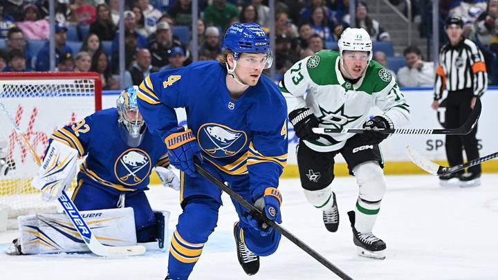 Apr 15, 2026; Buffalo, New York, USA; Buffalo Sabres defenseman Bowen Byram (4) clears the puck from the goal with Dallas Stars left wing Adam Erne (73) in pursuit in the third period at KeyBank Center. Mandatory Credit: Mark Konezny-Imagn Images