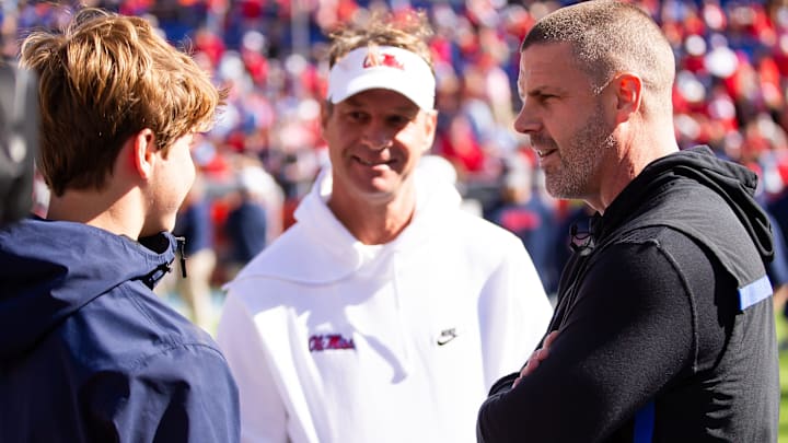 Florida Gators head coach Billy Napier talks with Mississippi Rebels head coach Lane Kiffin before the start of the game at Ben Hill Griffin Stadium in Gainesville, FL on Saturday, November 23, 2024. [Doug Engle/Gainesville Sun]