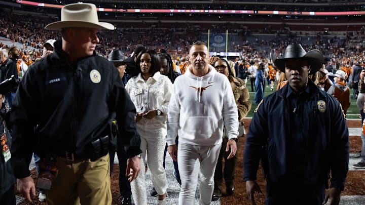 Dec 21, 2024; Austin, Texas, USA; Texas Longhorns head coach Steve Sarkisian with police officer escort against the Clemson Tigers during the CFP National playoff first round at Darrell K Royal-Texas Memorial Stadium. 