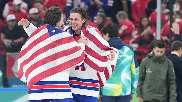 The Hughes brothers celebrate becoming Olympic gold medalists. 