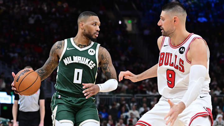 Nov 20, 2024; Milwaukee, Wisconsin, USA; Milwaukee Bucks guard Damian Lillard (0) drives against Chicago Bulls center Nikola Vucevic (9) in the fourth quarter at Fiserv Forum. Mandatory Credit: Benny Sieu-Imagn Images