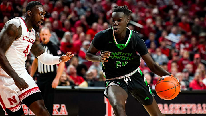 Dec 20, 2023; Lincoln, Nebraska, USA; North Dakota Fighting Hawks forward B.J. Omot (20) drives against Nebraska Cornhuskers forward Juwan Gary (4) during the second half at Pinnacle Bank Arena. Mandatory Credit: Dylan Widger-Imagn Images Dec 20, 2023; Lincoln, Nebraska, USA; North Dakota Fighting Hawks forward B.J. Omot (20) drives against Nebraska Cornhuskers forward Juwan Gary (4) during the second half at Pinnacle Bank Arena. Mandatory Credit: Dylan Widger-Imagn Images