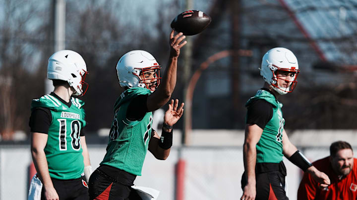 Louisville QB Deuce Adams (13) passes during practice outside the Trager Center in Louisville, Ky. on Mar. 1, 2025. Louisville QB Deuce Adams (13) passes during practice outside the Trager Center in Louisville, Ky. on Mar. 1, 2025.