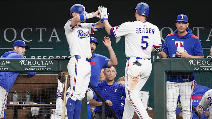 Apr 17, 2025; Arlington, Texas, USA; Texas Rangers shortstop Corey Seager (5) celebrates his solo home run with third baseman Josh Jung (6) against the Los Angeles Angels during the seventh inning at Globe Life Field. Seager’s home run was his 100th as a Texas Ranger.