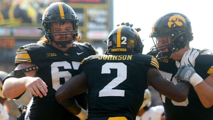Iowa’s Kaleb Johnson (2) celebrates with teammates after scoring a touchdown against Washington Saturday, Oct. 12, 2024 at Kinnick Stadium in Iowa City, Iowa.