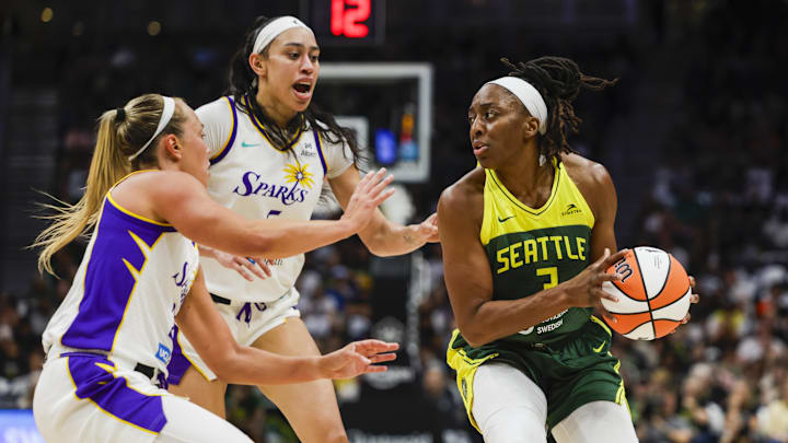 Sep 1, 2025; Seattle, Washington, USA; Seattle Storm forward Nneka Ogwumike (3) looks to pass away from a double team by Los Angeles Sparks forward Dearica Hamby (5) and guard Julie Allemand (20) during the second quarter at Climate Pledge Arena. Mandatory Credit: Joe Nicholson-Imagn Images