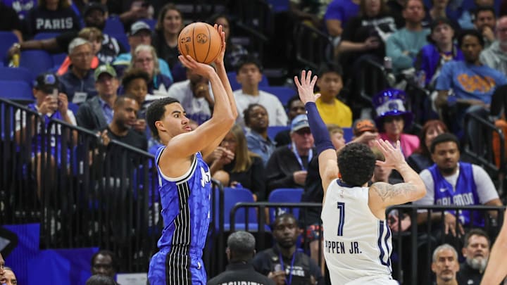 Orlando Magic guard Caleb Houstan (2) shoots a three point basket over Memphis Grizzlies guard Scotty Pippen Jr. (1) during the second half at KIA Center.