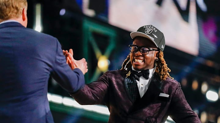 Ashton Jeanty slaps hands with NFL Commissioner Roger Goodell. Ashton Jeanty slaps hands with NFL Commissioner Roger Goodell.