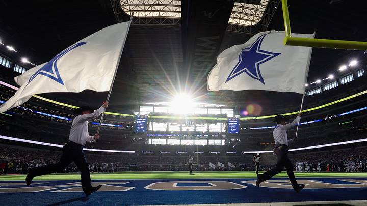 A general view of the field as flag runners run by after a Dallas Cowboys score against the Detroit Lions at AT&T Stadium. A general view of the field as flag runners run by after a Dallas Cowboys score against the Detroit Lions at AT&T Stadium.