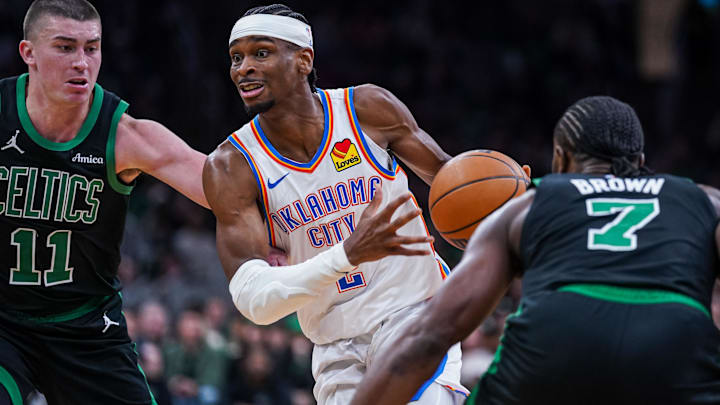Mar 12, 2025; Boston, Massachusetts, USA; Oklahoma City Thunder guard Shai Gilgeous-Alexander (2) drives the ball against Boston Celtics guard Payton Pritchard (11) and guard Jaylen Brown (7) in the third quarter at TD Garden. Mandatory Credit: David Butler II-Imagn Images