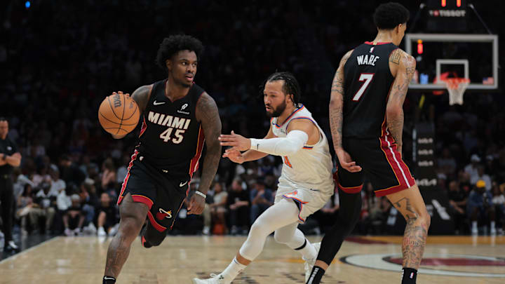 Mar 2, 2025; Miami, Florida, USA; Miami Heat guard Davion Mitchell (45) drives to the basket past New York Knicks guard Jalen Brunson (11) during the third quarter at Kaseya Center. Mandatory Credit: Sam Navarro-Imagn Images