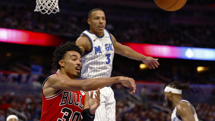 Oct 25, 2025; Orlando, Florida, USA;  Chicago Bulls guard Tre Jones (30) throws the pass to the outside as Orlando Magic guard Desmond Bane (3) defends in the second half at Kia Center. Mandatory Credit: Russell Lansford-Imagn Images