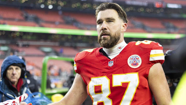 Dec 15, 2024; Cleveland, Ohio, USA; Kansas City Chiefs tight end Travis Kelce (87) gives his gloves to a fan following a game against the Cleveland Browns at Huntington Bank Field. Mandatory Credit: Scott Galvin-Imagn Images