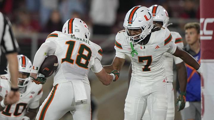 Sep 4, 2026; Stanford, California, USA;  Miami Hurricanes wide receiver Cooper Barkate (18) reacts with wide receiver Daylyn Upshaw (7) after catching a touchdown pass against the Stanford Cardinal during the third quarter at Stanford Stadium.  Mandatory Credit: Stan Szeto-Imagn Images