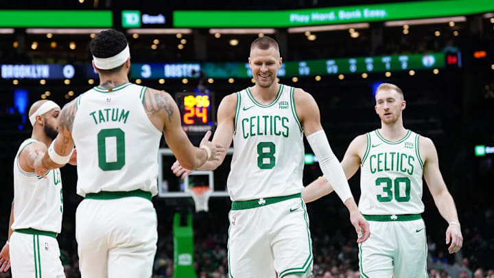 Boston Celtics center Kristaps Porzingis and forward Jayson Tatum react after a play against the Brooklyn Nets.