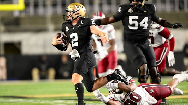 Nov 9, 2024; Nashville, Tennessee, USA; Vanderbilt Commodores quarterback Diego Pavia (2) breaks the tackle of South Carolina Gamecocks defensive tackle T.J. Sanders (90) during the second half at FirstBank Stadium. Mandatory Credit: Steve Roberts-Imagn Images Nov 9, 2024; Nashville, Tennessee, USA; Vanderbilt Commodores quarterback Diego Pavia (2) breaks the tackle of South Carolina Gamecocks defensive tackle T.J. Sanders (90) during the second half at FirstBank Stadium. Mandatory Credit: Steve Roberts-Imagn Images