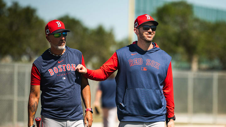 Boston Red Sox first base coach Jose Flores (left) and WooSox manager Chad Tracy walk on the back fields at JetBlue Park in Fort Myers, Florida on March 12, 2025.
