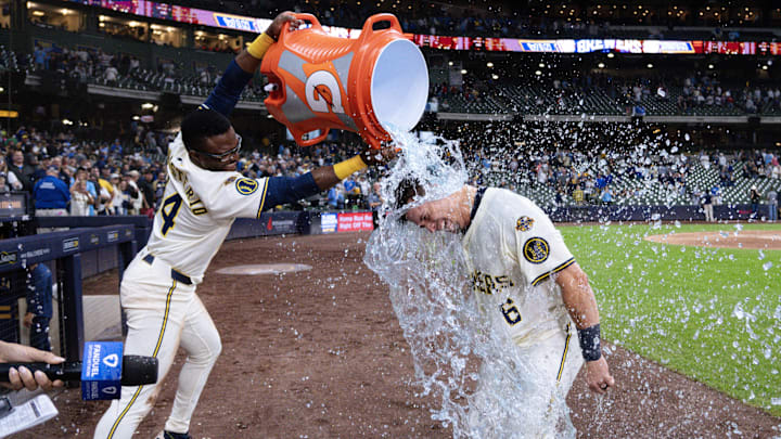 Aug 26, 2025; Milwaukee, Wisconsin, USA;  Milwaukee Brewers left fielder Isaac Collins (6) is dunked with Gatorade by  Andruw Monasterio (14) after driving in the winning run during the ninth inning against the Arizona Diamondbacks at American Family Field. Mandatory Credit: Jeff Hanisch-Imagn Images