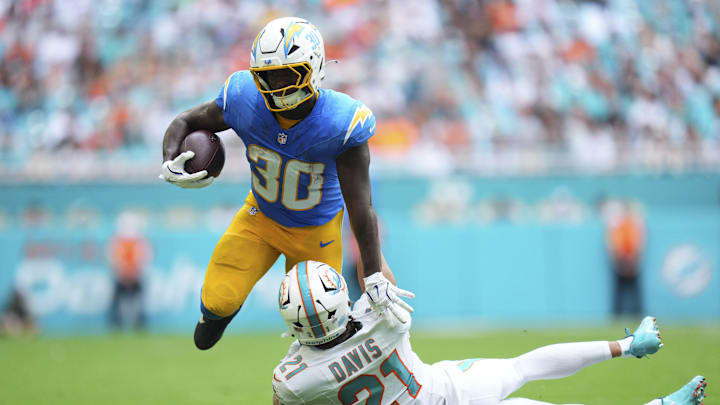 Oct 12, 2025; Miami Gardens, Florida, USA; Miami Dolphins safety Ashtyn Davis (21) tackles Los Angeles Chargers running back Kimani Vidal (30) during the second quarter at Hard Rock Stadium. Mandatory Credit: Rich Storry-Imagn Images Oct 12, 2025; Miami Gardens, Florida, USA; Miami Dolphins safety Ashtyn Davis (21) tackles Los Angeles Chargers running back Kimani Vidal (30) during the second quarter at Hard Rock Stadium. Mandatory Credit: Rich Storry-Imagn Images