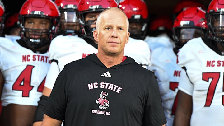 Sep 11, 2025; Winston-Salem, North Carolina, USA; North Carolina State Wolfpack head coach Dave Doeren walks his team out on the field against the Wake Forest Demon Deacons at Allegacy Federal Credit Union Stadium. Mandatory Credit: Luke Jamroz-Imagn Images Sep 11, 2025; Winston-Salem, North Carolina, USA; North Carolina State Wolfpack head coach Dave Doeren walks his team out on the field against the Wake Forest Demon Deacons at Allegacy Federal Credit Union Stadium. Mandatory Credit: Luke Jamroz-Imagn Images