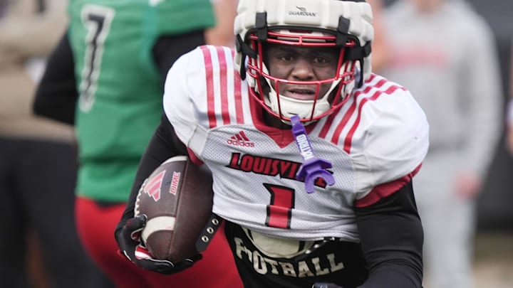 Louisville Isaac Brown (1) runs for a first down against Red Louisville in the Spring Game Friday night at L&N Stadium