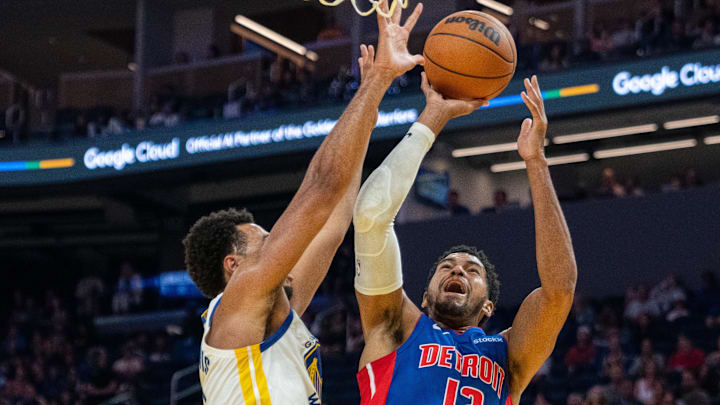 Oct 13, 2024; San Francisco, California, USA;  Detroit Pistons forward Tobias Harris (12) shoots a layup against Golden State Warriors forward Trayce Jackson-Davis (32) during the first quarter at Chase Center. Mandatory Credit: Neville E. Guard-Imagn Images