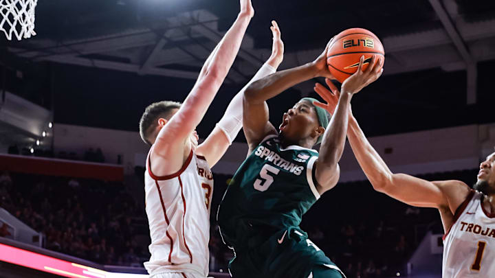 Feb 1, 2025; Los Angeles, California, USA; Michigan State Spartans guard Tre Holloman (5) shoots the ball against the USC Trojans at Galen Center. Mandatory Credit: William Navarro-Imagn Images Feb 1, 2025; Los Angeles, California, USA; Michigan State Spartans guard Tre Holloman (5) shoots the ball against the USC Trojans at Galen Center. Mandatory Credit: William Navarro-Imagn Images