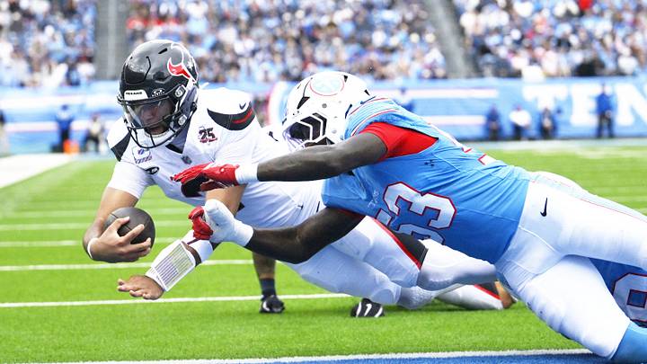 Oct 11, 2026; Nashville, Tennessee, USA;  Houston Texans quarterback C.J. Stroud (7) scores a touchdown against Tennessee Titans linebacker Anthony Hill Jr. (53) during the third quarter at Nissan Stadium.  Mandatory Credit: Steve Roberts-Imagn Images