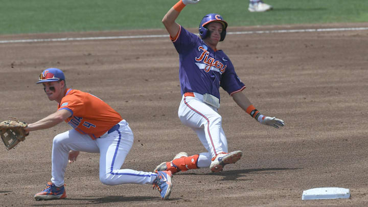 Jun 9, 2024; Clemson, SC, USA; Clemson sophomore Jack Crighton (3) slides into second base near Florida sophomore Cade Kurland (4) during the top of the third inning of the NCAA baseball Clemson Super Regional at Doug Kingsmore Stadium. Mandatory Credit: Ken Ruinard - USA TODAY Sports