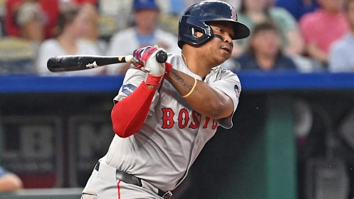  Boston Red Sox third baseman Rafael Devers (11) singles in the fifth inning against the Kansas City Royals at Kauffman Stadium.