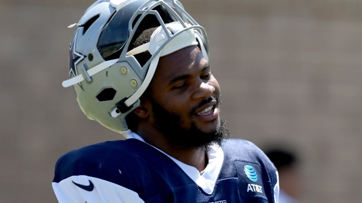 Dallas Cowboys linebacker Micah Parsons talks to assistant coach Domata Peko during training camp.