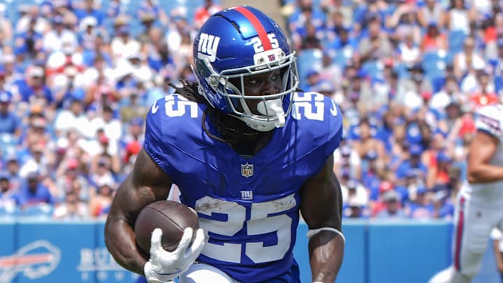 Aug 9, 2025; Orchard Park, New York, USA; New York Giants running back Dante Miller (25) runs with the ball against the Buffalo Bills during the first half at Highmark Stadium.  