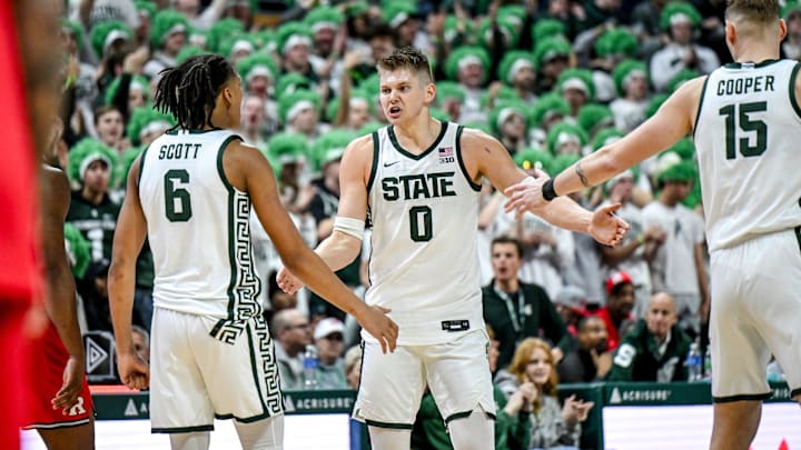 Michigan State's Jaxon Kohler, center, celebrates with Jordan Scott, left, and Carson Cooper after Kohler's 3-pointer against Rutgers during the second half on Thursday, March 5, 2026, at the Breslin Center in East Lansing.