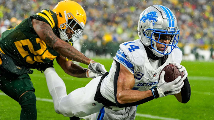 Detroit Lions receiver Amon-Ra St. Brown makes a catch for a touchdown against Green Bay Packers cornerback Keisean Nixon.