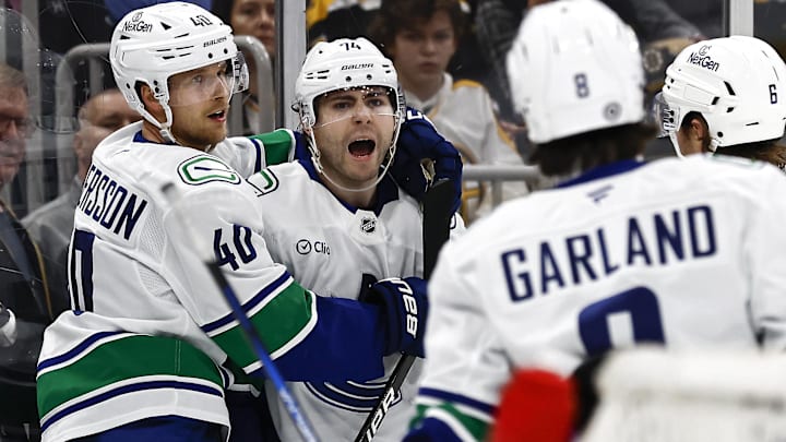 Nov 26, 2024; Boston, Massachusetts, USA; Vancouver Canucks left wing Jake DeBrusk (74) is congratulated by center Elias Pettersson (40) after scoring against the Boston Bruins during the second period at TD Garden. Mandatory Credit: Winslow Townson-Imagn Images