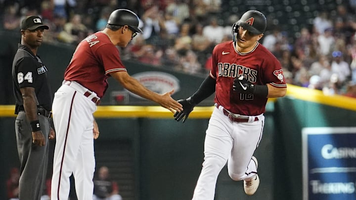 Sep 4, 2022; Phoenix, AZ, USA; Arizona Diamondbacks' Daulton Varsho (12) high fives third base coach