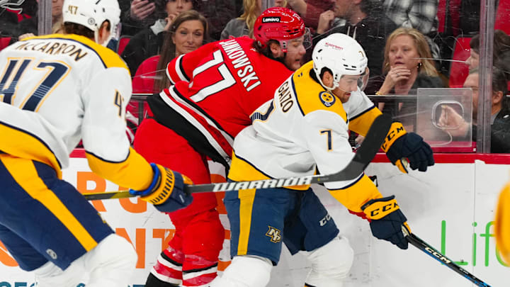 Mar 25, 2025; Raleigh, North Carolina, USA; Nashville Predators defenseman Marc Del Gaizo (7) checks Carolina Hurricanes center Mark Jankowski (77) during the first period at Lenovo Center. Mandatory Credit: James Guillory-Imagn Images Mar 25, 2025; Raleigh, North Carolina, USA; Nashville Predators defenseman Marc Del Gaizo (7) checks Carolina Hurricanes center Mark Jankowski (77) during the first period at Lenovo Center. Mandatory Credit: James Guillory-Imagn Images