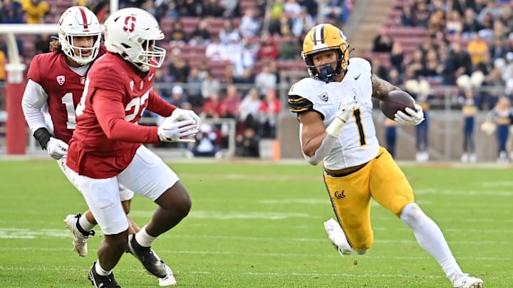Nov 18, 2023; Stanford, California, USA; California Golden Bears running back Jaydn Ott (1) runs with the football against Stanford Cardinal linebacker David Bailey (23) during the first quarter at Stanford Stadium. Mandatory Credit: Robert Edwards-Imagn Images