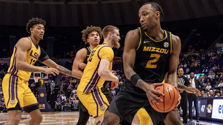 Mar 9, 2024; Baton Rouge, Louisiana, USA; Missouri Tigers guard Tamar Bates (2) dribbles against LSU Tigers forward Hunter Dean (12) and forward Jalen Reed (13) during the second half at Pete Maravich Assembly Center. Mandatory Credit: Stephen Lew-Imagn Images Mar 9, 2024; Baton Rouge, Louisiana, USA; Missouri Tigers guard Tamar Bates (2) dribbles against LSU Tigers forward Hunter Dean (12) and forward Jalen Reed (13) during the second half at Pete Maravich Assembly Center. Mandatory Credit: Stephen Lew-Imagn Images