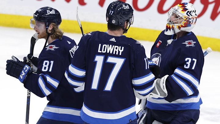 Mar 4, 2023; Winnipeg, Manitoba, CAN; Winnipeg Jets left wing Kyle Connor (81), Winnipeg Jets center Adam Lowry (17) and Winnipeg Jets goaltender Connor Hellebuyck (37) celebrate their win over the Edmonton Oilers at Canada Life Centre. Mandatory Credit: James Carey Lauder-Imagn Images