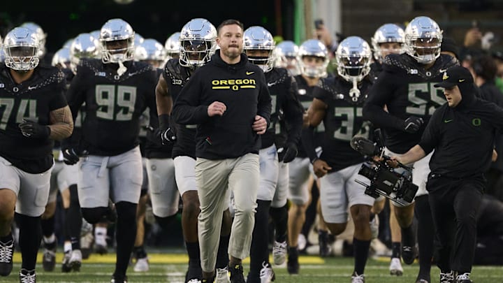 Nov 30, 2024; Eugene, Oregon, USA; Oregon Ducks head coach Dan Lanning runs out with the team before a game against the Washington Huskies at Autzen Stadium